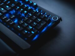 gamer playing mmorpg at night with rgb keyboard