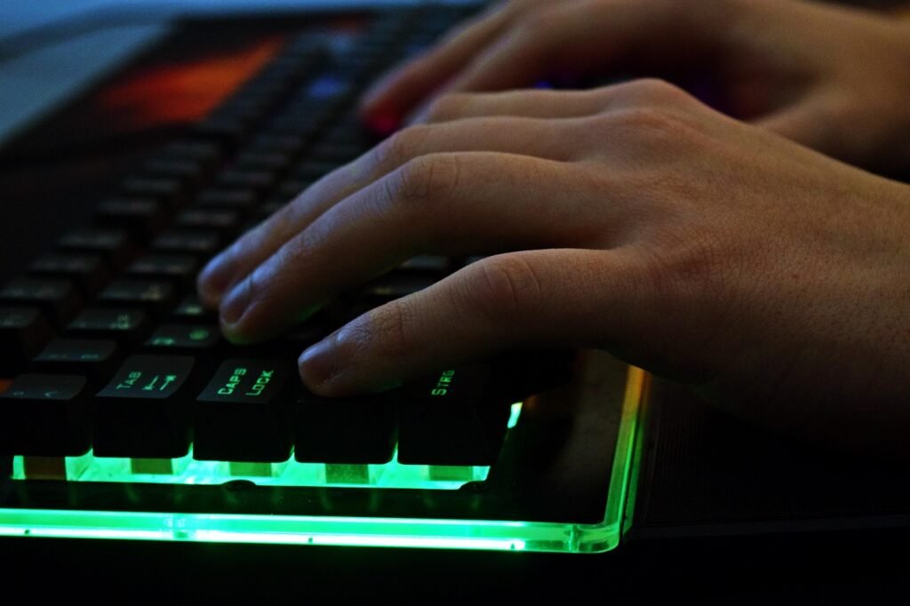 hands typing on laptop keyboard