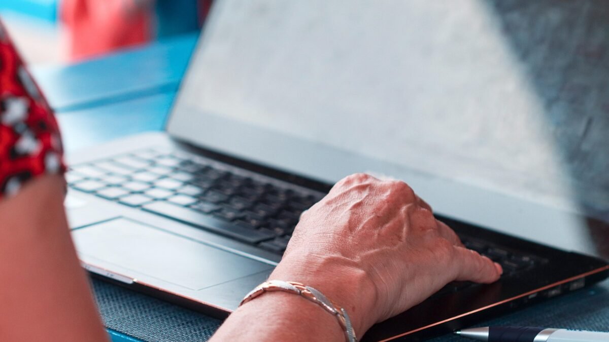 hands typing on laptop keyboard