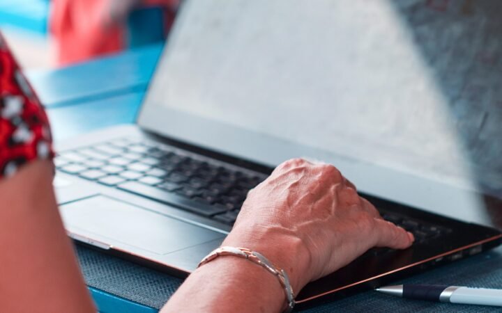 hands typing on laptop keyboard