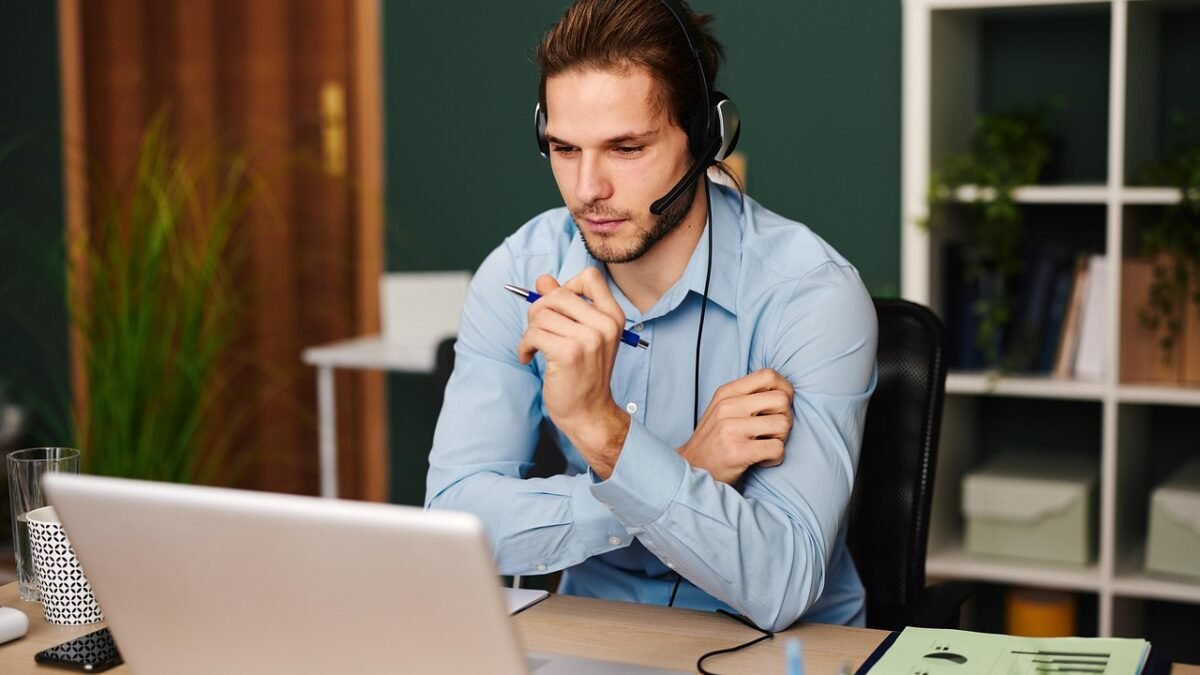 person on video call with headset at home