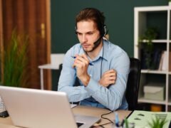 person on video call with headset at home