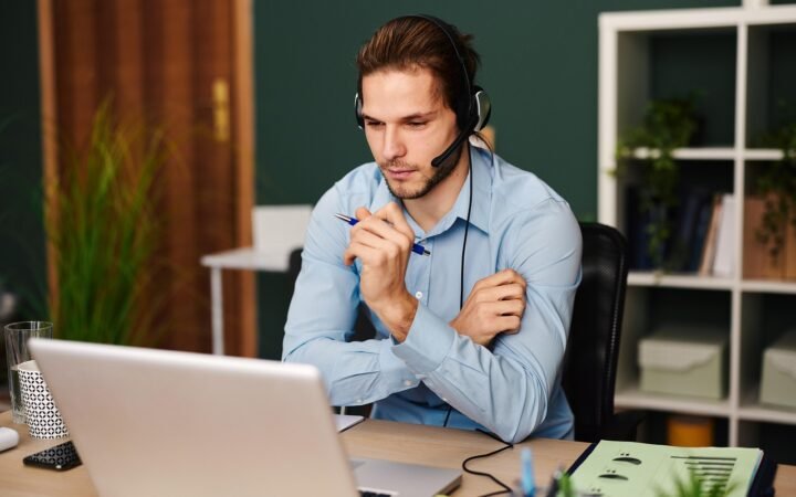 person on video call with headset at home