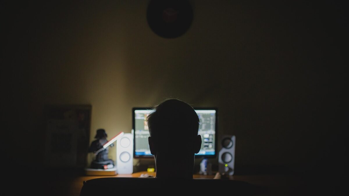 person working laptop home office night