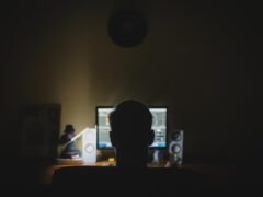 person working laptop home office night