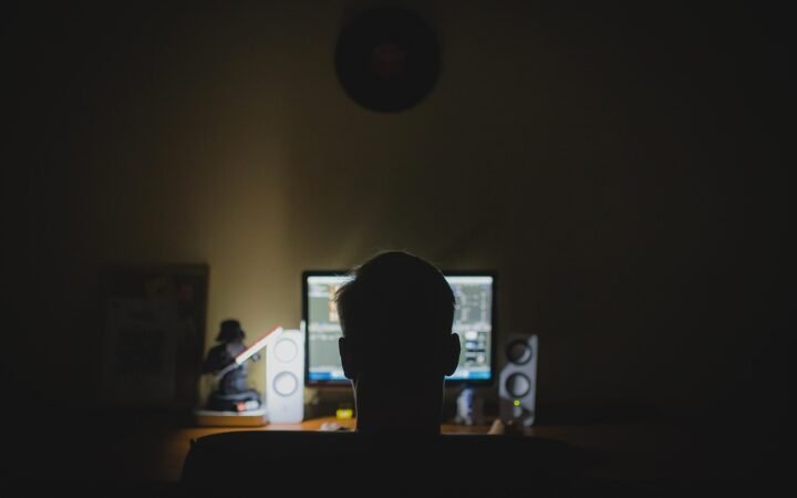 person working laptop home office night